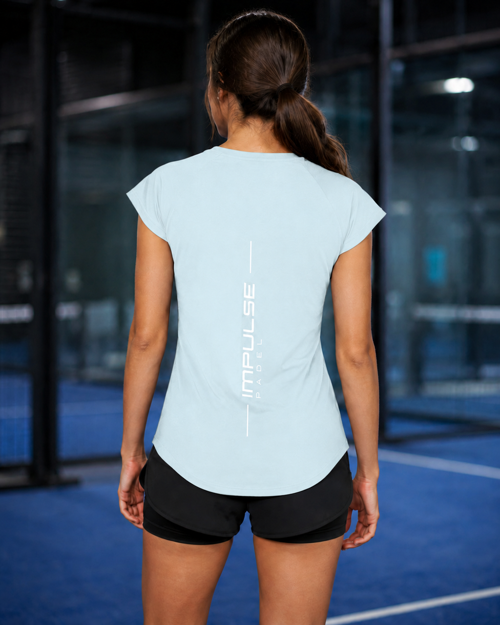 T-shirt technique femme bleu glacier vu de dos avec marquage vertical Impulse Padel
